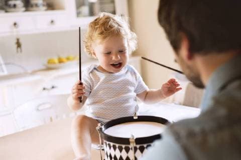 Father with happy little boy sitting on kitchen table playing drum model released Symbolfoto property released  HAPF02285