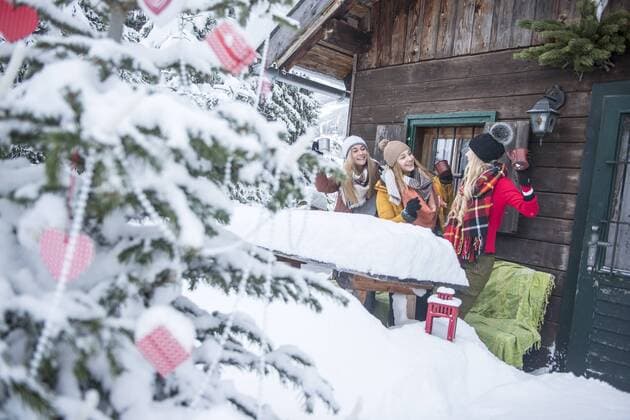 Austria, Altenmarkt-Zauchensee, female friends celebrating at wooden house at Christmas time model released Symbolfoto property released  HHF05504
