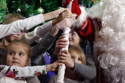 MOSCOW, RUSSIA - DECEMBER 6, 2017: Children touch the staff of Father Frost from Veliky Ustyug at a press conference held at the Russkaya Pesnya (Russian Song) Moscow State Folklore Music Theatre ahead of the upcoming New Year holidays. Artyom Geodakyan TASS  TS06C231