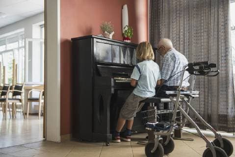 Grandfather teaching piano instrument to his grandson, Eichenau, Bavaria, Germany mit_2017_10080