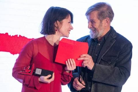 MOSCOW, RUSSIA - DECEMBER 15, 2017: Sasha Pirogova (entry MONO ), left, winner of the 11th Kandinsky Prize in the Young Artist: Project of the Year category, receives her award from writer Boris Orlov at the 11th Kandinsky Prize ceremony at the Udarnik Cinema. Sergei Bobylev TASS  TS06D53B
