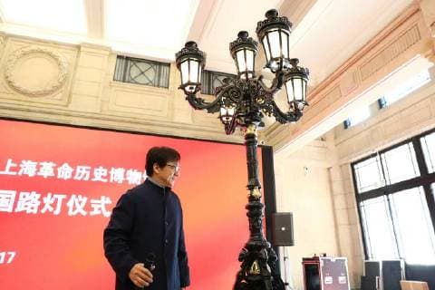 Hong Kong kungfu star Jackie Chan attends a ceremony to mark his donation of an antique street lamp and six replicas to the Shanghai History Museum in Shanghai, China, 17 December 2017. Jackie Chan on Sunday (17 December 2017) donated an antique street lamp and six replicas to the Shanghai History Museum. The 63-year-old film actor posed for pictures with one of the replicas during a ceremony at the museum at 325 Nanjing Road W. The original lamp is undergoing restoration, the museum said. Chan, a keen antiques collector outside his movie career, said he spotted a number of ornate street lamps on sale while filming in the United States many years ago. The Taiwan couple selling them said they were from Shanghai during the Republic of China (1912-1949) period. He bought 19 lamps from the couple at up to US$4,500 each and had them shipped  pbu726482_03