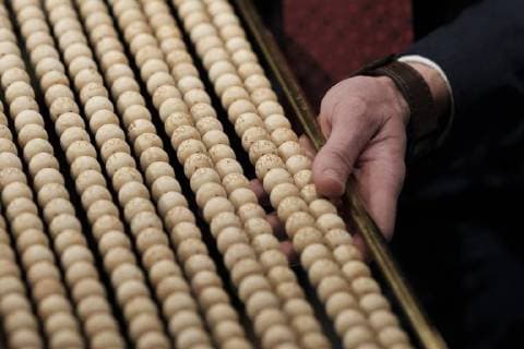 December 22, 2017 - Madrid, Spain - Officials check a ball bearing with the lottery ticket number of an spectator during the draw of Spain s Christmas lottery named El Gordo (Fat One) at the Teatro Real on December 22, 2017 in Madrid, Spain. The winning number wins a total of 4 million euros for the top prize to be shared between ten ticket holders Madrid Spain  - ZUMAn230 20171222_zaa_n230_346 Copyright: xOscarxGonzalezx