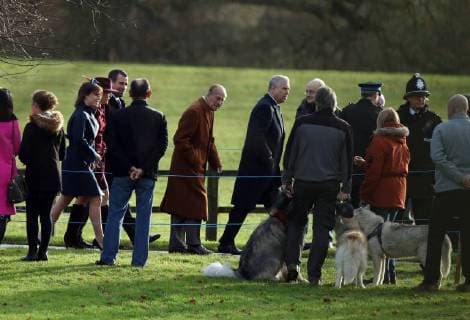 Prince Philip, Duke of Edinburgh, behind Prince Andrew, Duke of York, looks at some large dogs on his way to the St. Mary Magdalene Church Sunday morning service, on Christmas Eve, in Sandringham, Norfolk, on December 24, 2017. 