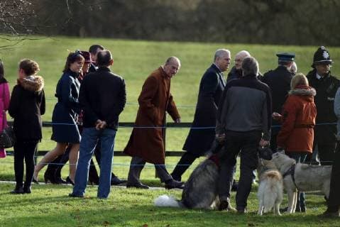 Prince Philip, Duke of Edinburgh, looks at some large dogs on his way to the St. Mary Magdalene Church Sunday morning service, on Christmas Eve, in Sandringham, Norfolk, on December 24, 2017. 