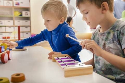 Two boys playing with musical instruments and toys in kindergarten model released Symbolfoto property released  MFF04089