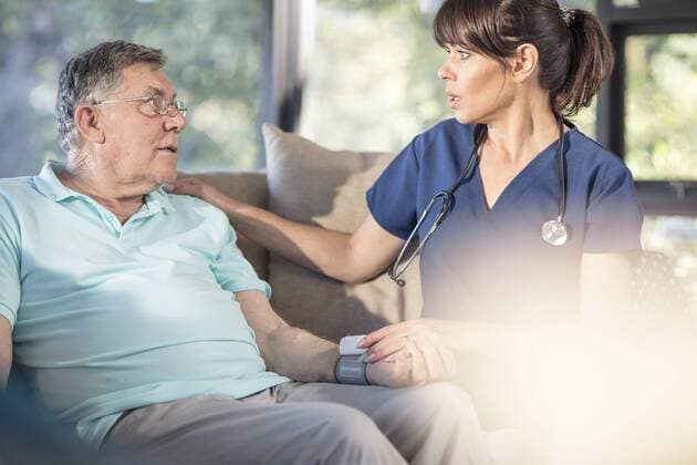 Nurse caring for of senior patient at home model released Symbolfoto property released  ZEF14782