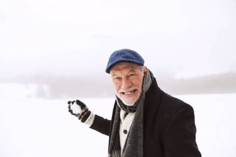 Portrait of senior man holding snowball model released Symbolfoto  HAPF02227