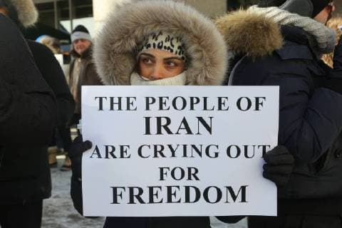 January 6, 2018 - Toronto, Ontario, Canada - Protestor holds a sign saying The People of Iran are Crying out for Freedom as hundreds of Canadians take part in a protest against the Islamic Republic of Iran in Toronto, Ontario, Canada, on January 06, 2018. Protestors showed their solidarity with anti-government demonstrators in Iran and their support of a national uprising of the Iranian people. Protesters called for a regime change for social justice and freedom and democracy in Iran. There was a also a call that power in Iran be returned to Reza Pahlavi, the former Crown Prince of Iran and the last heir apparent to the defunct throne of the Imperial State of Iran and the current head of the exiled House of Pahlavi. Toronto Canada  - ZUMAn230 20180106_zaa_n230_1115 Copyright: xCreativexTouchxImagingxLtdx