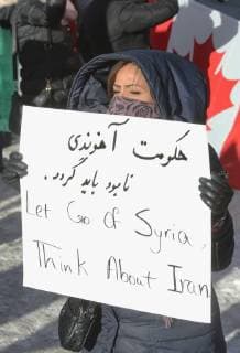 January 6, 2018 - Toronto, Ontario, Canada - Protestor holds a sign saying Let Go of Syria, Think about Iran as hundreds of Canadians take part in a protest against the Islamic Republic of Iran in Toronto, Ontario, Canada, on January 06, 2018. Protestors showed their solidarity with anti-government demonstrators in Iran and their support of a national uprising of the Iranian people. Protesters called for a regime change for social justice and freedom and democracy in Iran. There was a also a call that power in Iran be returned to Reza Pahlavi, the former Crown Prince of Iran and the last heir apparent to the defunct throne of the Imperial State of Iran and the current head of the exiled House of Pahlavi. Toronto Canada  - ZUMAn230 20180106_zaa_n230_1126 Copyright: xCreativexTouchxImagingxLtdx