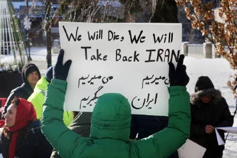 January 6, 2018 - Toronto, Ontario, Canada - Protestor holds a sign saying We Will Die, We Will Take Back Iran as hundreds of Canadians take part in a protest against the Islamic Republic of Iran in Toronto, Ontario, Canada, on January 06, 2018. Protestors showed their solidarity with anti-government demonstrators in Iran and their support of a national uprising of the Iranian people. Protesters called for a regime change for social justice and freedom and democracy in Iran. There was a also a call that power in Iran be returned to Reza Pahlavi, the former Crown Prince of Iran and the last heir apparent to the defunct throne of the Imperial State of Iran and the current head of the exiled House of Pahlavi. Toronto Canada  - ZUMAn230 20180106_zaa_n230_1145 Copyright: xCreativexTouchxImagingxLtdx