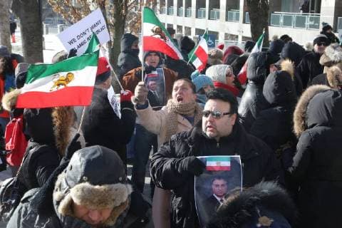 January 6, 2018 - Toronto, Ontario, Canada - Protestors hold photos of Reza Pahlavi (the former Crown Prince of Iran) as hundreds of Canadians take part in a protest against the Islamic Republic of Iran in Toronto, Ontario, Canada, on January 06, 2018. Protestors showed their solidarity with anti-government demonstrators in Iran and their support of a national uprising of the Iranian people. Protesters called for a regime change for social justice and freedom and democracy in Iran. There was a also a call that power in Iran be returned to Reza Pahlavi, the former Crown Prince of Iran and the last heir apparent to the defunct throne of the Imperial State of Iran and the current head of the exiled House of Pahlavi. Toronto Canada  - ZUMAn230 20180106_zaa_n230_1136 Copyright: xCreativexTouchxImagingxLtdx