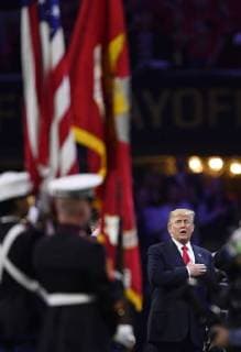 President Donald Trump participates in the National Anthem before the first half of the NCAA College Football Playoff National Championship at Mercedes-Benz Stadium on January 8, 2018 in Atlanta.  CFP20180108319 DAVIDxTULIS