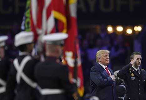 President Donald Trump participates in the National Anthem before the first half of the NCAA College Football Playoff National Championship at Mercedes-Benz Stadium on January 8, 2018 in Atlanta.  CFP20180108321 DAVIDxTULIS