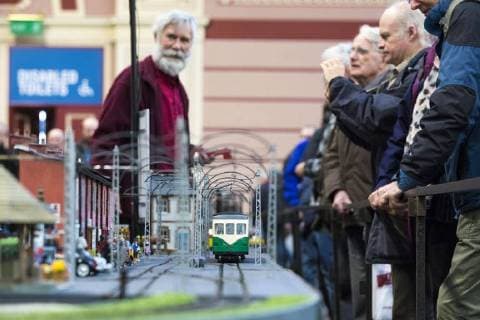 January 19, 2018 - London, London, UK - London, UK. Enthusiasts watch as a model tram passes along a miniature street at the London Model Engineering Exhibition at Alexandra Palace. Over 50 clubs and societies are exhibiting nearly 2,000 models constructed by their members. London UK  - ZUMAl94_ 20180119_zaf_l94_016 Copyright: xRobxPinneyx
