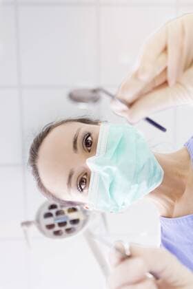 Personal perspective of female dentist with mask at work model released Symbolfoto property released  MMAF00214
