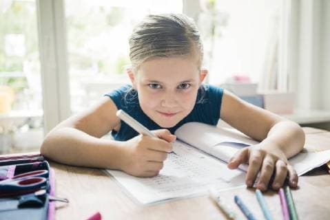 Portrait of girl doing homework at table model released Symbolfoto property released  MOEF00557