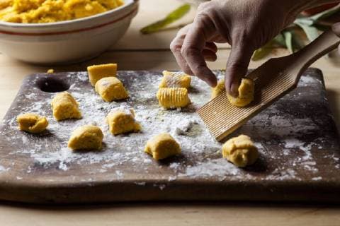 Preparing pumpkin gnocchi, rolling on wooden board model released Symbolfoto  SBDF03394