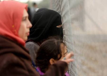 January 28, 2018 - Nuseirat, Gaza Strip, Palestinian Territory - Palestinian women watch the football match between Al-Nuseirat and Al-Jalaa standing outside the fence of the stadium, at Nuseirat refugee camp, in the central of Gaza Strip, on January 28, 2018. Palestinian police allowed women to attending the football match on the first time in Gaza Strip Nuseirat Palestinian Territory - ZUMAap3_ 20180128_zaf_ap3_155 Copyright: xAshrafxAmrax