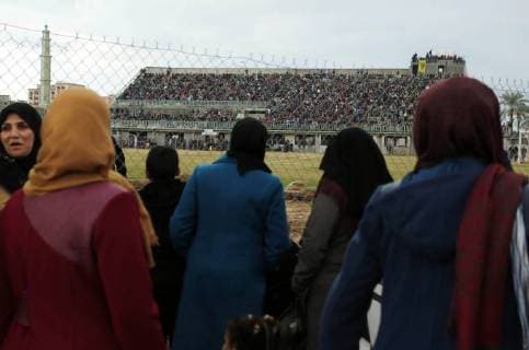 January 28, 2018 - Nuseirat, Gaza Strip, Palestinian Territory - Palestinian women watch the football match between Al-Nuseirat and Al-Jalaa standing outside the fence of the stadium, at Nuseirat refugee camp, in the central of Gaza Strip, on January 28, 2018. Palestinian police allowed women to attending the football match on the first time in Gaza Strip Nuseirat Palestinian Territory - ZUMAap3_ 20180128_zaf_ap3_158 Copyright: xAshrafxAmrax