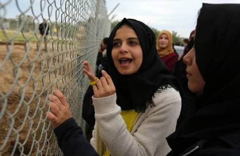 January 28, 2018 - Nuseirat, Gaza Strip, Palestinian Territory - Palestinian women watch the football match between Al-Nuseirat and Al-Jalaa standing outside the fence of the stadium, at Nuseirat refugee camp, in the central of Gaza Strip, on January 28, 2018. Palestinian police allowed women to attending the football match on the first time in Gaza Strip Nuseirat Palestinian Territory - ZUMAap3_ 20180128_zaf_ap3_161 Copyright: xAshrafxAmrax