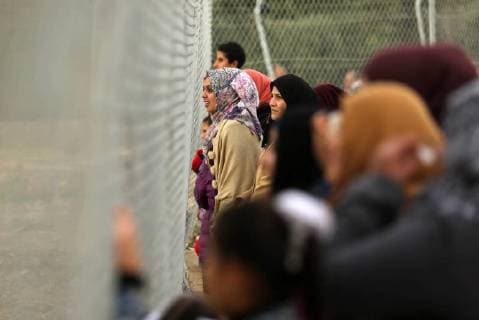 January 28, 2018 - Nuseirat, Gaza Strip, Palestinian Territory - Palestinian women watch the football match between Al-Nuseirat and Al-Jalaa standing outside the fence of the stadium, at Nuseirat refugee camp, in the central of Gaza Strip, on January 28, 2018. Palestinian police allowed women to attending the football match on the first time in Gaza Strip Nuseirat Palestinian Territory - ZUMAap3_ 20180128_zaf_ap3_179 Copyright: xAshrafxAmrax