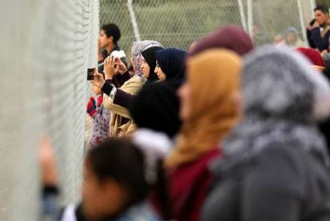 January 28, 2018 - Nuseirat, Gaza Strip, Palestinian Territory - Palestinian women watch the football match between Al-Nuseirat and Al-Jalaa standing outside the fence of the stadium, at Nuseirat refugee camp, in the central of Gaza Strip, on January 28, 2018. Palestinian police allowed women to attending the football match on the first time in Gaza Strip Nuseirat Palestinian Territory - ZUMAap3_ 20180128_zaf_ap3_182 Copyright: xAshrafxAmrax