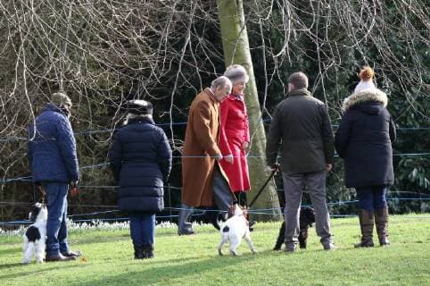 People with their dogs watch Prince Philip, Duke of Edinburgh, attending the St. Mary Magdalene Church Sunday morning service, in Sandringham, Norfolk, on January 28, 2018 