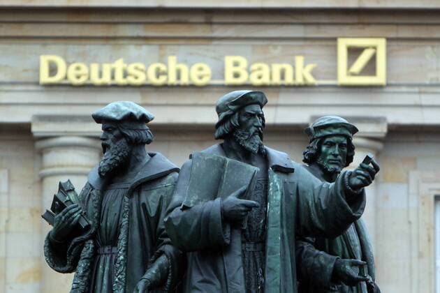 Logo and lettering Deutsche Bank behind the Gutenberg monument to the horse market in the banking district of Frankfurt Hessen Germany