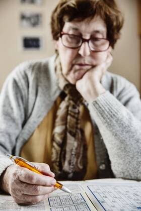 Senior citizen home sits at the table and solve puzzle Sudoku crossword Cologne Nordrhein Westfalen Germany Europe Copyright: imageBROKER/JanxTepass ibxjte04634735.jpg