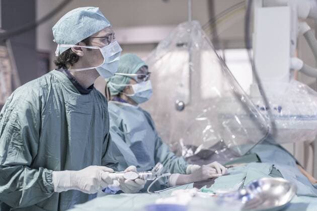 Neuroradiologist with assistant in scrubs preparing an operation model released Symbolfoto property released  MWEF00172