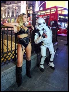. 26 02 2018. London, United Kingdom. Beast from the East - London Weather. A storm trooper photo bombs a model wearing only lingerie as she braves the freezing weather to pose for a film crew in London s Piccadilly Circus.  xPetexMaclainex xi-Imagesx IIM-17072-0003