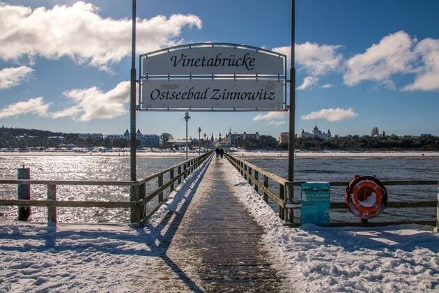 The Ostseebad Zinnowitz in winter Snowy beach and ice at the pier