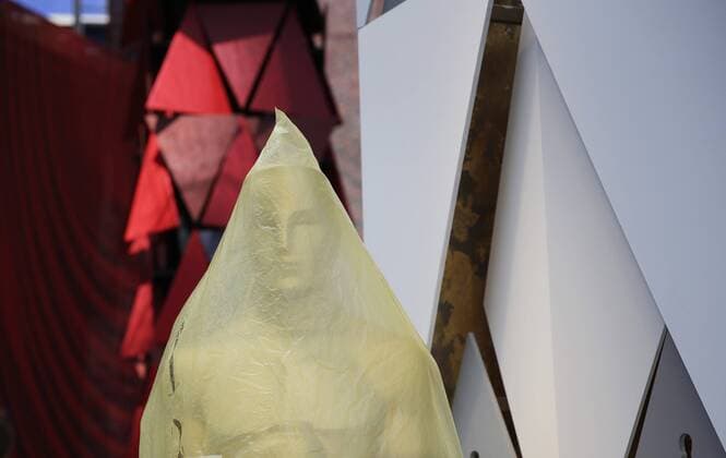 An Oscar statue is wrapped in plastic on the red carpet as preparations continue for the 90th annual Academy Awards in the Hollywood section of Los Angeles on March 3, 2018. Oscar winners will be announced during an ABC telecast on Sunday, March 4th at the Dolby Theatre.  LAP20180303903 JOHNxANGELILLO