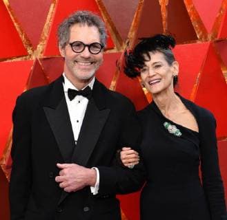 Production designer Dennis Gassner (L) and guest arrive on the red carpet for the 90th annual Academy Awards at the Dolby Theatre in the Hollywood section of Los Angeles on March 4, 2018.  LAP20180304511 JIMxRUYMEN