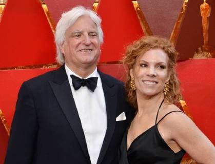 Producer Mark Mitten (R) and guest arrive on the red carpet for the 90th annual Academy Awards at the Dolby Theatre in the Hollywood section of Los Angeles on March 4, 2018.  LAP20180304524 JIMxRUYMEN