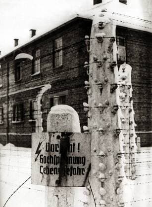 Auschwitz Concentration Camp A barbed wire fence with a danger warning sign Danger high voltage mortal danger The camp was liberated by soldiers of the Soviet Union from the 1 Ukrainian Front under the command of Marshal Ivanovich Konev Poland Date 27 January 1945