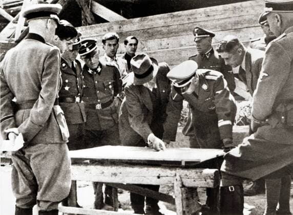 Heinrich Himmler middle right and Max Faust chief engineer middle left at Himmlers visit to the Monowitz Buna works in Auschwitz Poland Date 17 July 1942