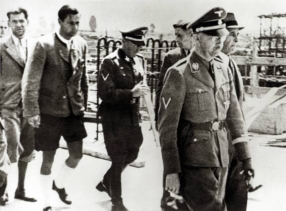 Reichsführer SS Heinrich Himmler on the right and Max Faust Chief Engineer on the far right in Himmlers visit to the Monowitz Buna Works in Auschwitz Poland Date 17 July 1942