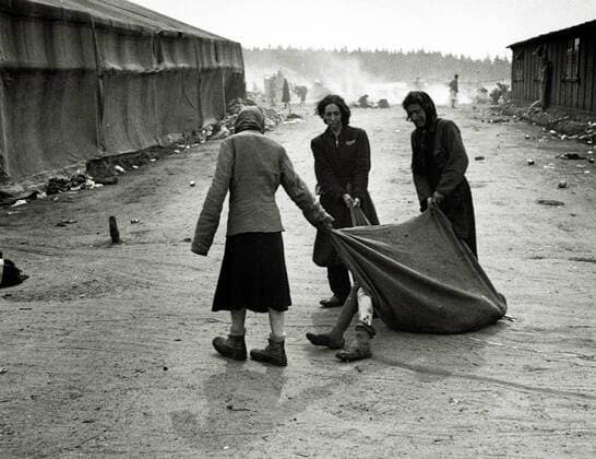 Bergen Belsen concentration camp Inmates drag the body of a sick person to the Allied 21st Army Group after handing over the camp 55,000 inmates were found with typhoid and dysentery 13,000 former inmates died after the liberation of Germany Date 15 April 1945