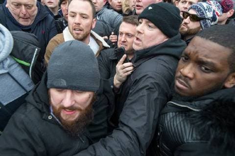 March 18, 2018 - London, London, UK - London , UK . TOMMY ROBINSON (top centre) pushes his way from the crowd to leave after delivering his speech . 1000s including supporters of alt-right groups such as Generation Identity and the Football Lads Alliance , at Speakers Corner in Hyde Park where Tommy Robinson reads a speech by Generation Identity campaigner Martin Sellner . Along with Brittany Pettibone , Sellner was due to deliver the speech last week but the pair were arrested and detained by police when they arrived in the UK , forcing them to cancel an appearance at a UKIP Young Independence youth event , which in turn was reportedly cancelled amid security concerns London UK  - ZUMAl94_ 20180318_zaf_l94_098 Copyright: xJoelxGoodmanx