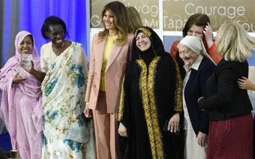 United States First Lady Melania Trump laughs as she stands for a photo with winners of the 2018 International Women of Courage Award, including L Malouma Said of Mauritania, Godelieve Mukasarasi of Rwanda, Dr. Julissa Villanueva of Honduras, Aliyah Khalaf Saleh of Iraq, Aiman Umarova of Kazakhstan, Sister Maria Elena Berini of Italy, and Dr. Fredide Rushdi of Kosovo during the Award Ceremony at the State Department in Washington, DC on March 23, 2018.  WAP20180323902 LEIGHxVOGEL