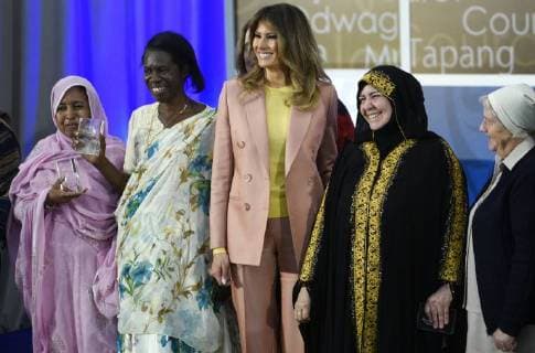 United States First Lady Melania Trump laughs as she stands for a photo with winners of the 2018 International Women of Courage Award, including L Malouma Said of Mauritania, Godelieve Mukasarasi of Rwanda, Dr. Julissa Villanueva of Honduras, Aliyah Khalaf Saleh of Iraq, Aiman Umarova of Kazakhstan, and Sister Maria Elena Berini of Italy during the Award Ceremony at the State Department in Washington, DC on March 23, 2018.  WAP20180323907