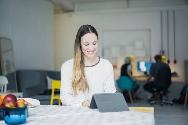 Portrait of smiling young businesswoman working on tablet in a loft model released Symbolfoto property released  MOEF00712