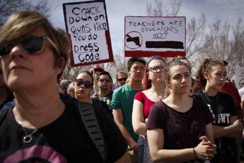 March 24, 2018 - Albuquerque, New Mexico, U.S - EMMA YAKLEY (CQ), far right in black, age 17, JESSICA ALBANNA (CQ), second from right in purple, age 16, LILLIAN ESTES (CQ), third from right in red, age 17, and MASON CANNON (CQ), fourth from right in green age 15, all four attend Albuquerque High School and are all from Albuquerque, N.M., attend a rally with thousands of people at Tiguex Park in Albuquerque during the March For Our Lives rally in Albuquerque, New Mexico Saturday March 24, 2018. Albuquerque U.S. - ZUMAv88_ 20180324_zap_v88_021 Copyright: xPatxVasquez-Cunninghamx