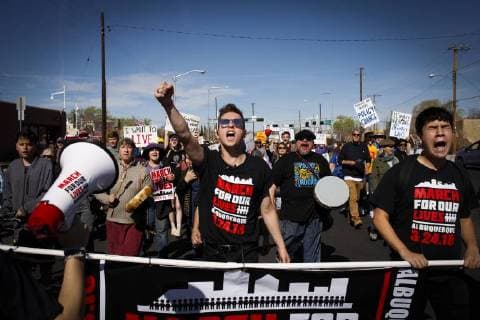 March 24, 2018 - Albuquerque, New Mexico, U.S - Youth organizer nineteen year old BLAIR DIXON, center, leads thousands of marchers in a chant during the March For Our Lives rally in Albuquerque, New Mexico Saturday March 24, 2018. At right is fifteen year old youth organizer JONATHON ALONZO Albuquerque U.S. - ZUMAv88_ 20180324_zap_v88_004 Copyright: xPatxVasquez-Cunninghamx