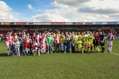 The two teams line up for a photo ahead of the Celebrity Charity Football Match hosted by Sellebrity Soccer for the Benjamin Lewis Charity Cub at the Abbey Business Stadium, Cheltenham, England on 25 March 2018. Copyright: xDavidxHornx PMI-1918