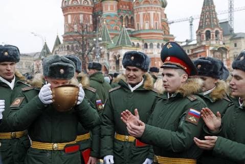 MOSCOW, RUSSIA - MARCH 31, 2018: The 2013-2018 graduating cohort of students of the Moscow Military Music School drink from a helmet as they celebrate in Red Square. Mikhail Metzel TASS  TS07A0DC