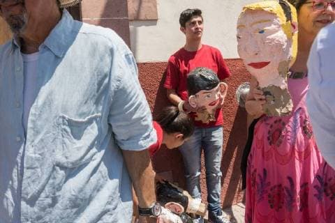 April 1, 2018 - San Miguel De Allende, Guanajuato, Mexico - People walk away with the head of an effigy of U.S. President Donald Trump after it was exploded during the Burning of Judas Easter-time ritual marking the end of Holy Week April 1, 2018 in San Miguel de Allende, Mexico. While the tradition includes burning a paper effigy of Judas a recent popular addition has been paper doll caricatures of Donald Trump across Mexico. San Miguel De Allende Mexico - ZUMAe02_ 20180401_zaf_e02_010 Copyright: xRichardxEllisx