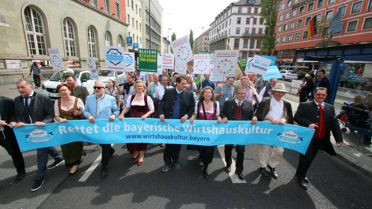 Large demoatration and work stoppage by employees in the hotel and catering industry by the DEHOGA Deutscher Hotel und Gaststättenverband in Munich Bavaria Germany Country Manager Thomas Geppert with Ingrid Hartges and Angela Inselkammer at the top of the demo train with banner saves the Bavarian tavern culture